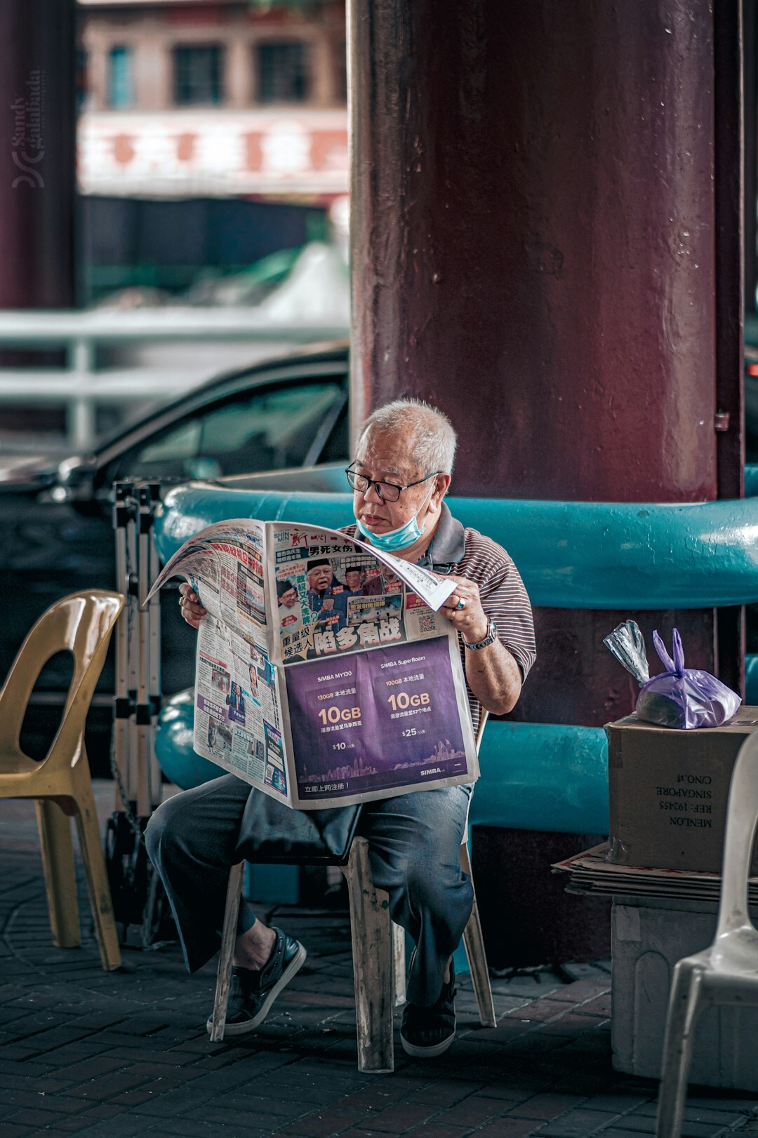 elderly person reading newspaper