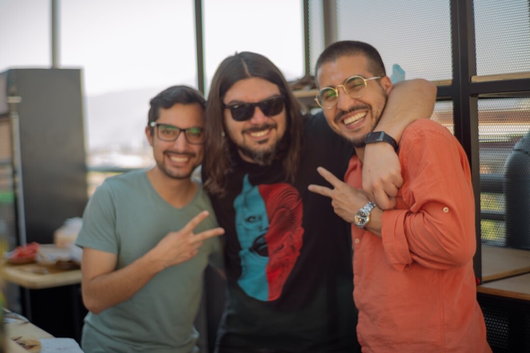 Diverse team of frontpixel.org staff smiling together in an office