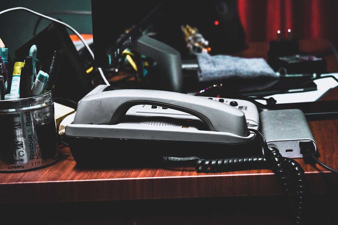 Friendly Croatian support assistant talking on the phone at a desk